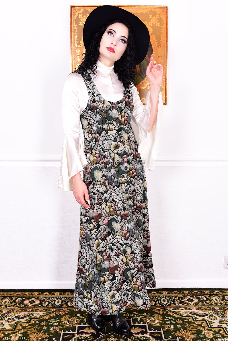Woman wearing a vintage 1970s floral tapestry dress by Marion Donaldson and black hat.
