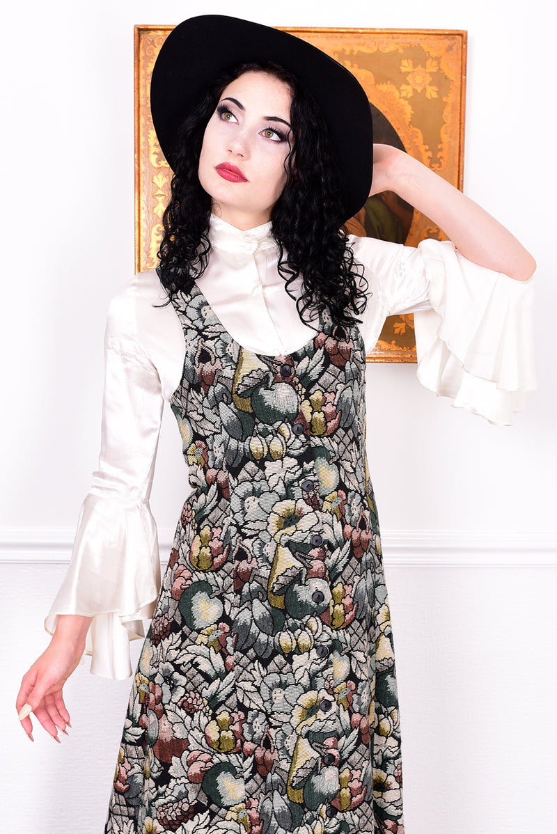 Woman wearing a vintage 1970s floral tapestry dress by Marion Donaldson and black hat.