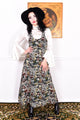 Woman wearing a vintage 1970s floral tapestry dress by Marion Donaldson and black hat.