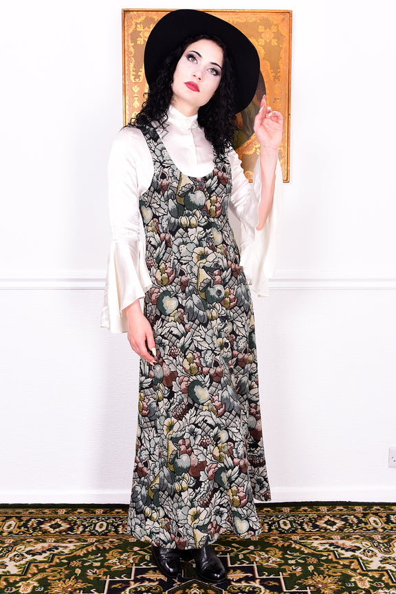 Woman wearing a vintage 1970s floral tapestry dress by Marion Donaldson and black hat.