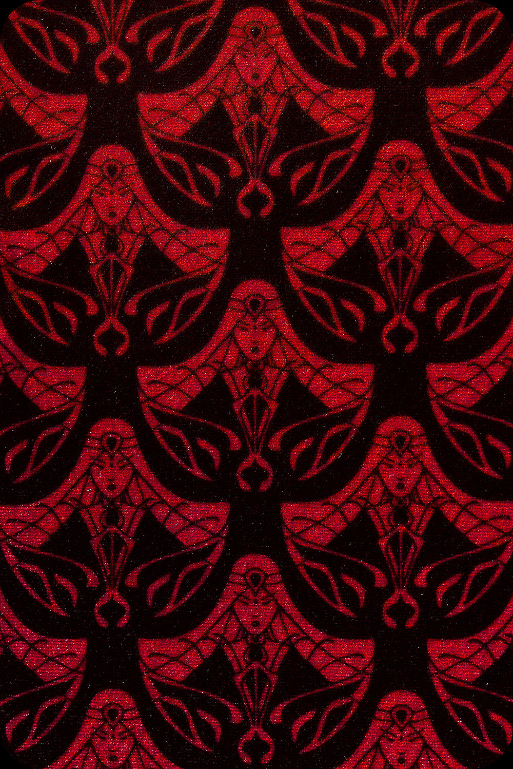 A pair of red logo print velvet bell bottom trousers by Scorpio Rising