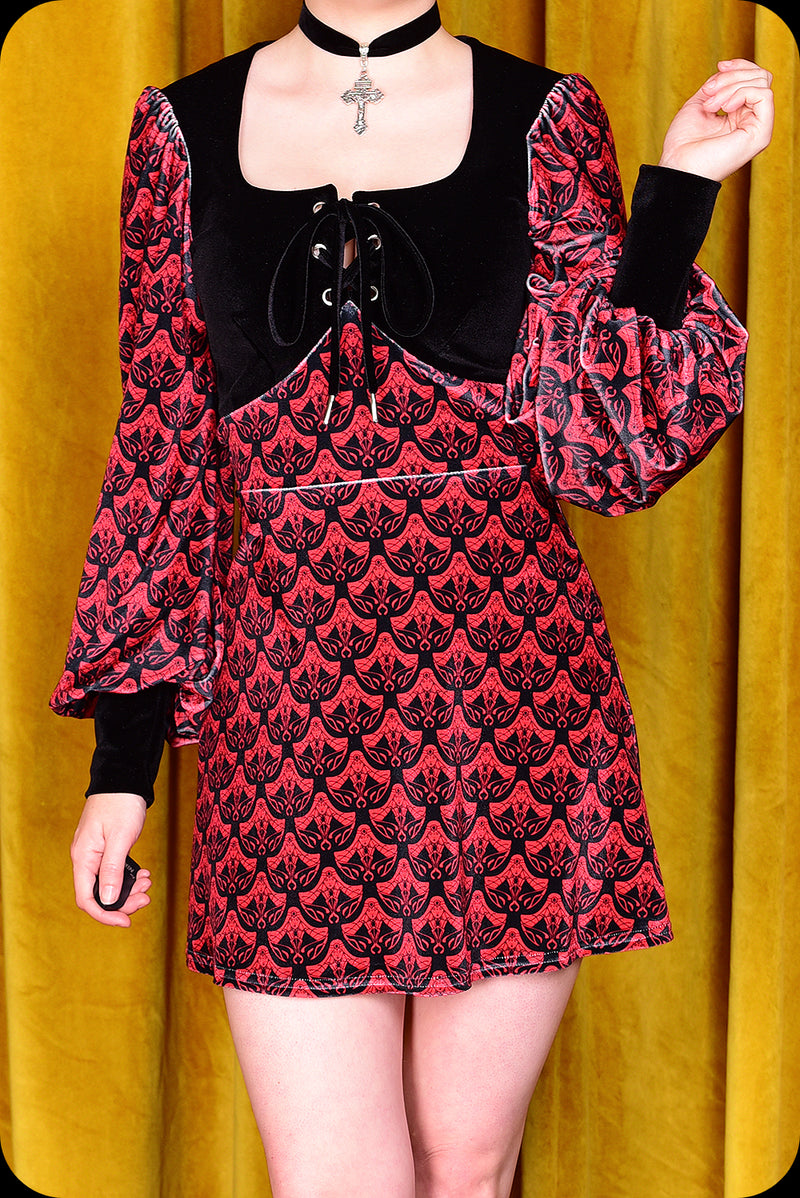 A red logo print velvet Carmilla mini dress by Scorpio Rising