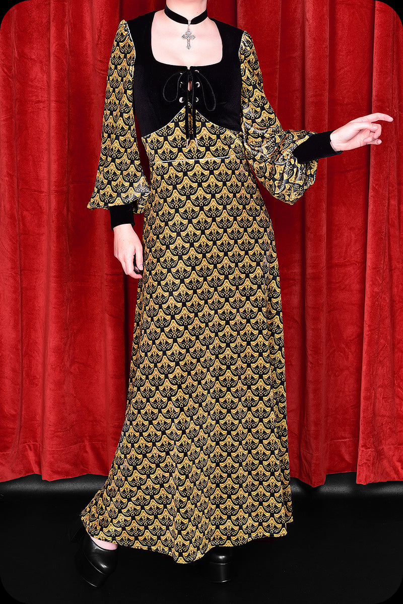 A gold logo print velvet Carmilla maxi dress by Scorpio Rising