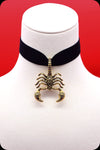 A black velvet antique gold scorpion choker necklace by Scorpio Rising