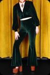 An emerald green velvet Supiria bell bottom co-ord set by Scorpio Rising