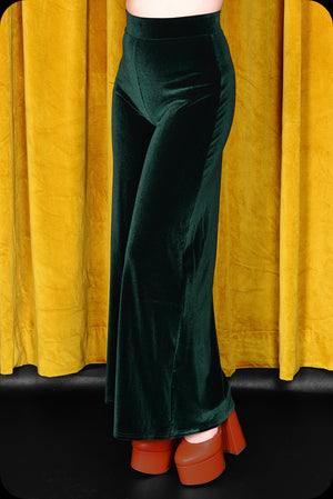 A pair of emerald green velvet wide leg trousers by Scorpio Rising