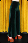 A pair of emerald green velvet wide leg trousers by Scorpio Rising
