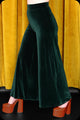 A pair of emerald green velvet wide leg trousers by Scorpio Rising