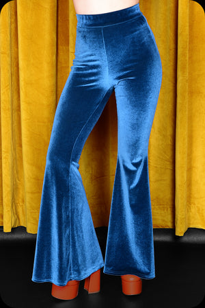 A pair of peacock blue velvet bell bottom trousers by Scorpio Rising