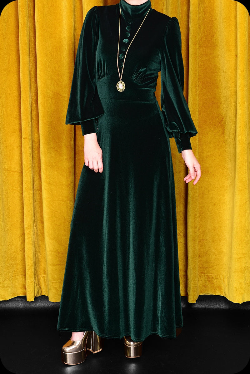 An emerald green velvet Morgiana maxi dress by Scorpio Rising