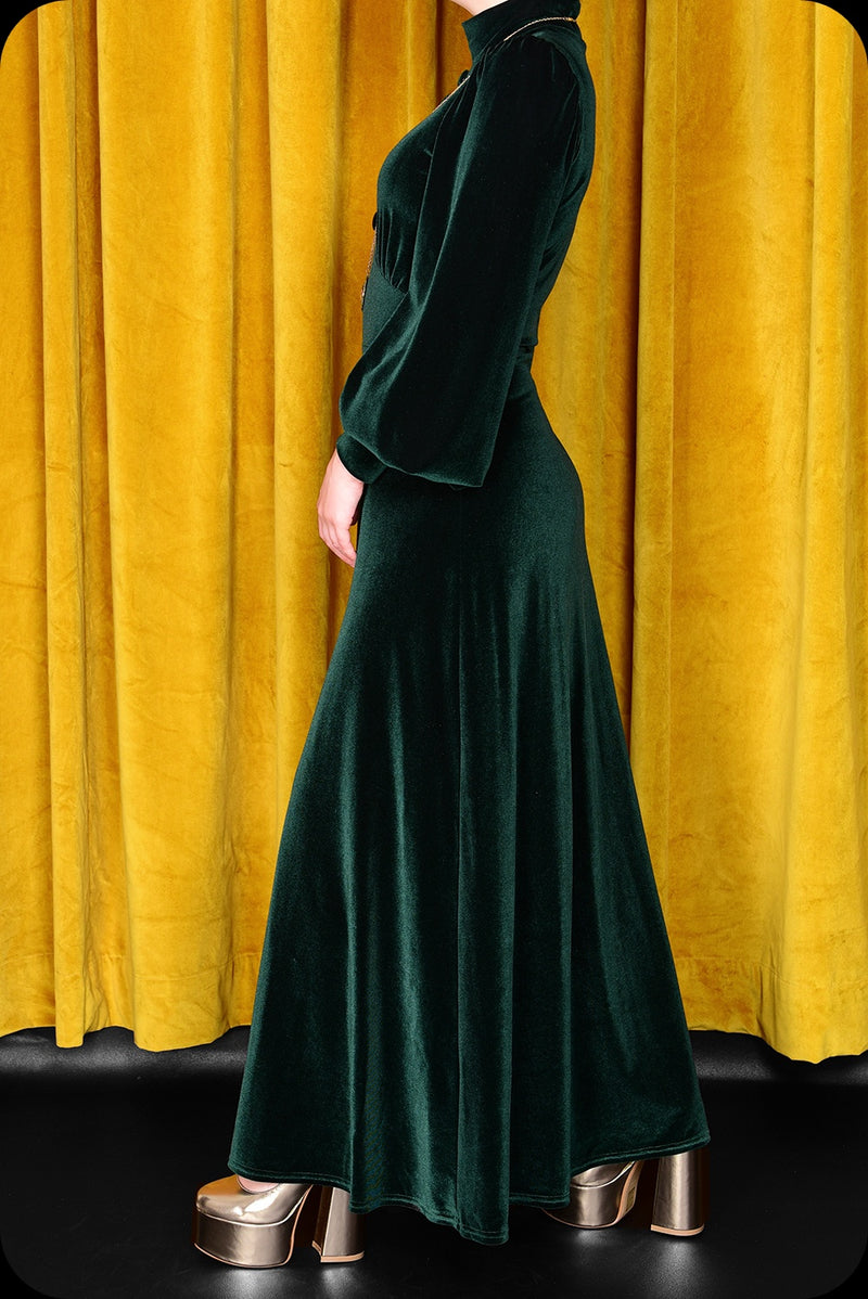 An emerald green velvet Morgiana maxi dress by Scorpio Rising