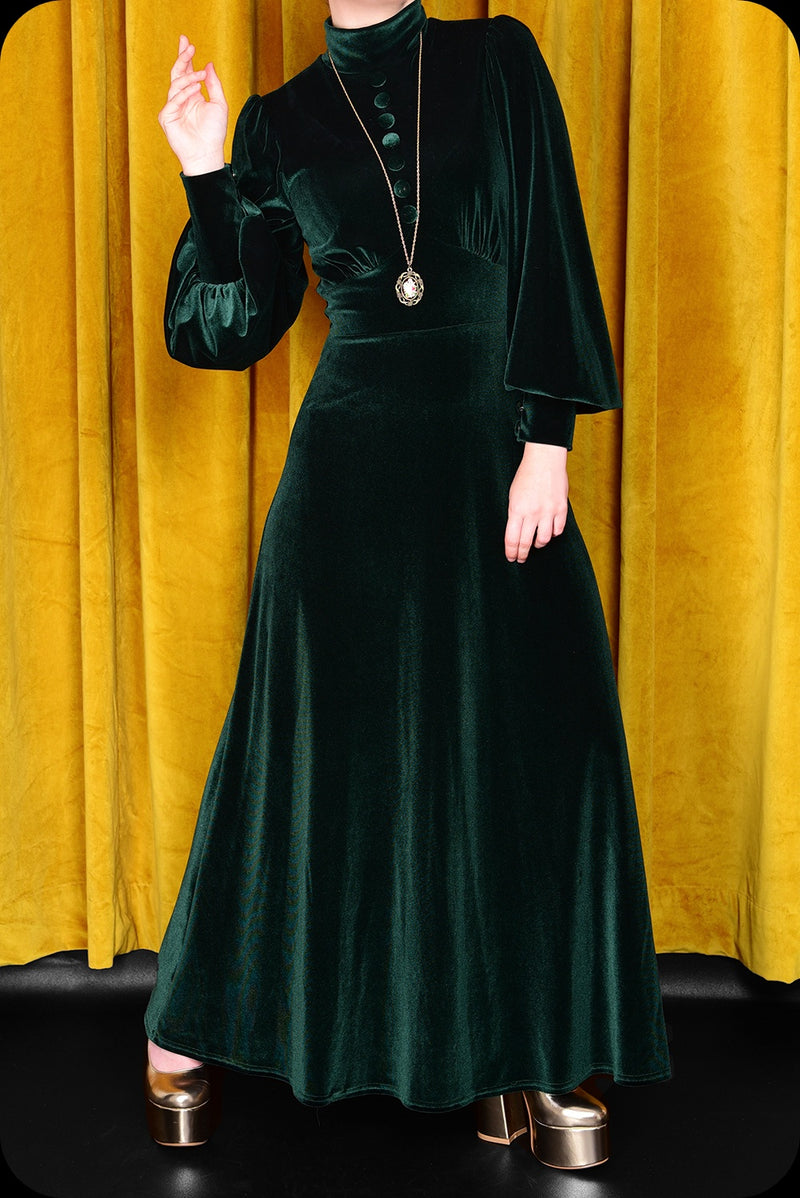 An emerald green velvet Morgiana maxi dress by Scorpio Rising